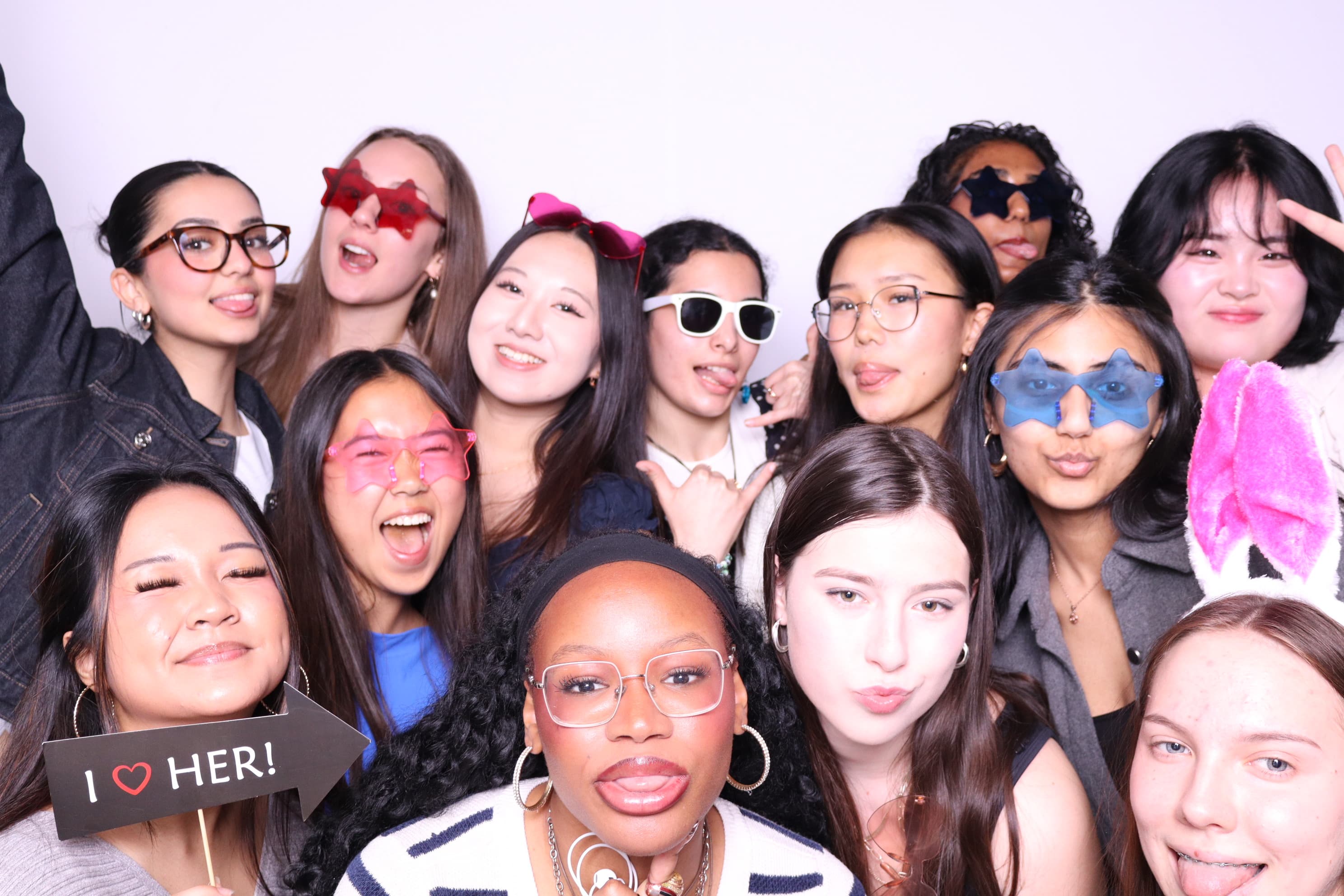 Large group of friends with fun props at photo booth Vancouver