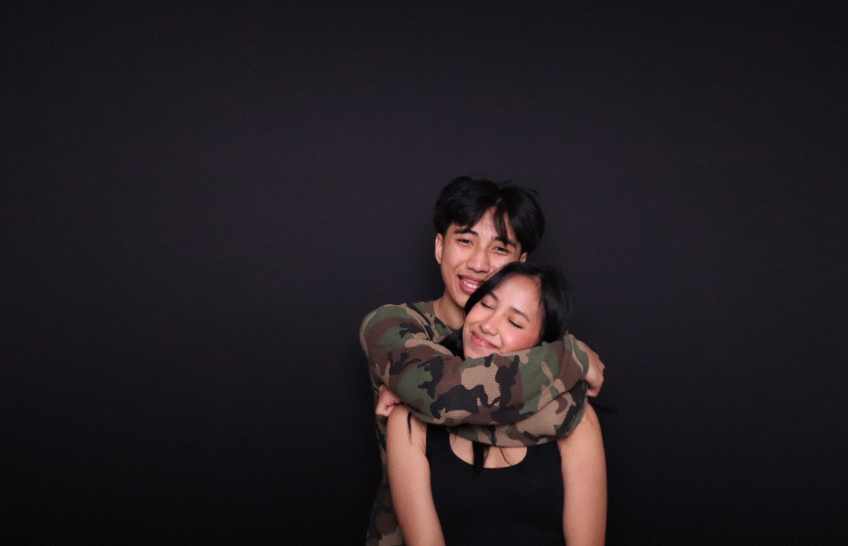 Couple hugging at photo booth party Vancouver