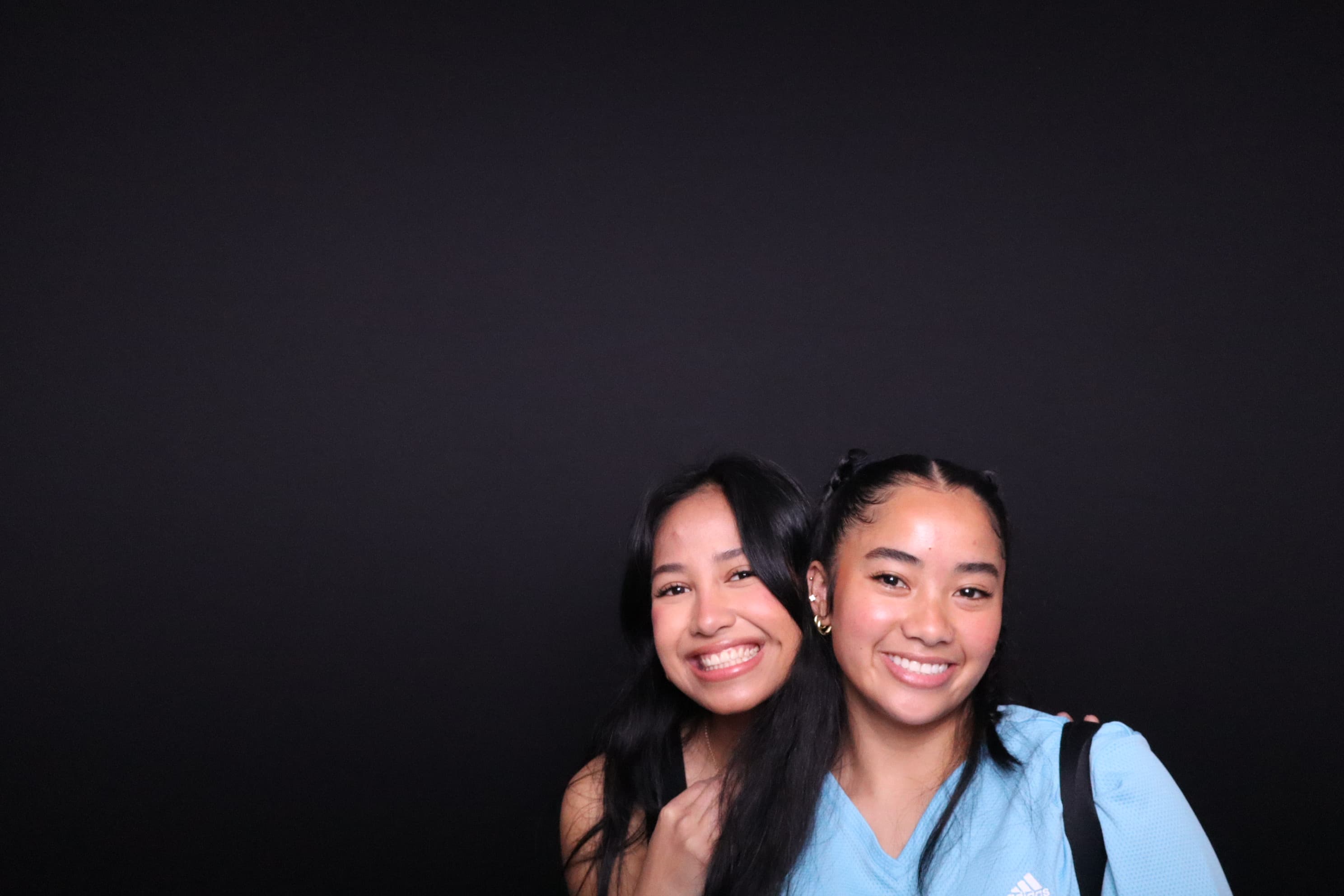 Two friends smiling at photo booth birthday event Vancouver