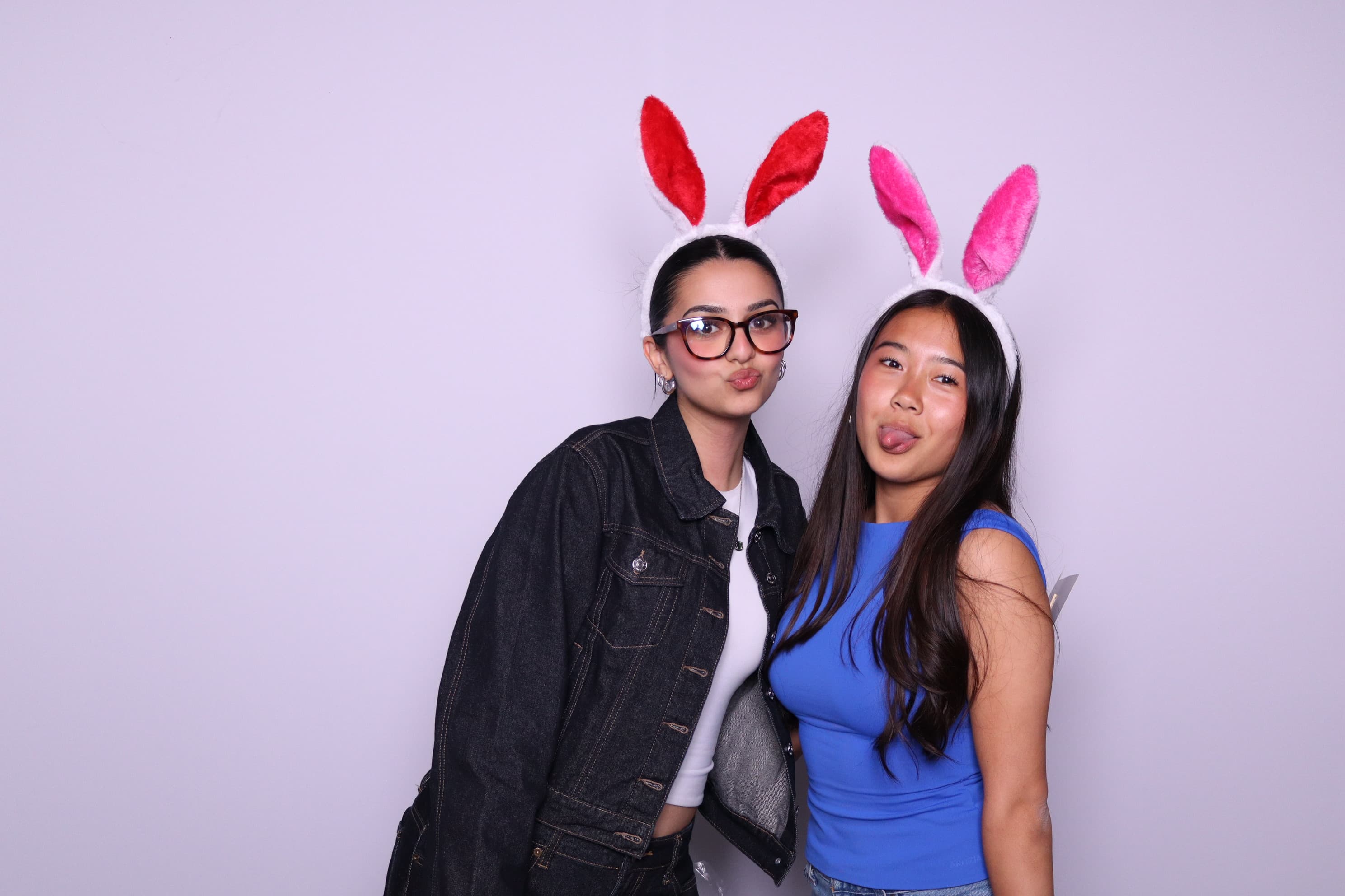 Two friends wearing bunny ears at photo booth event