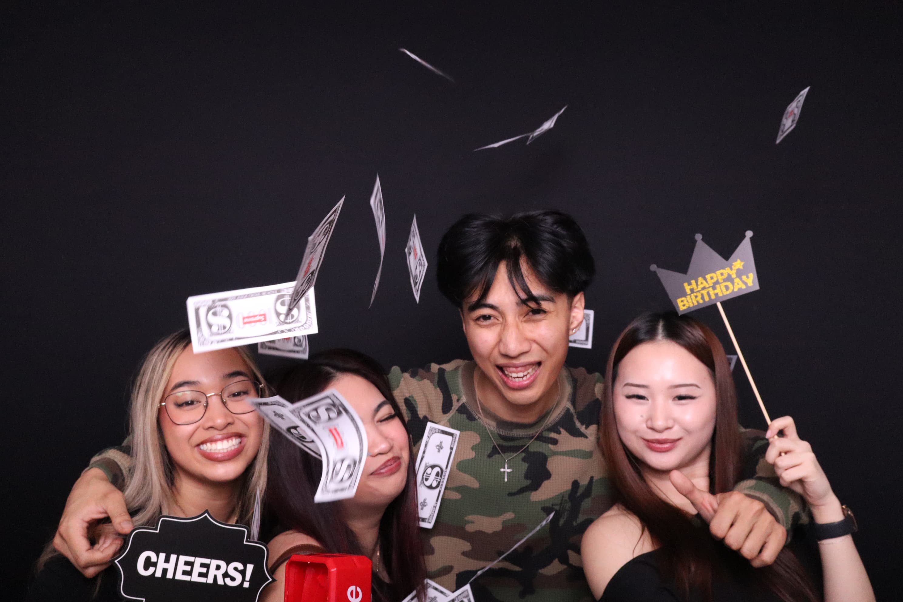 Friends with birthday props and money at photo booth Vancouver