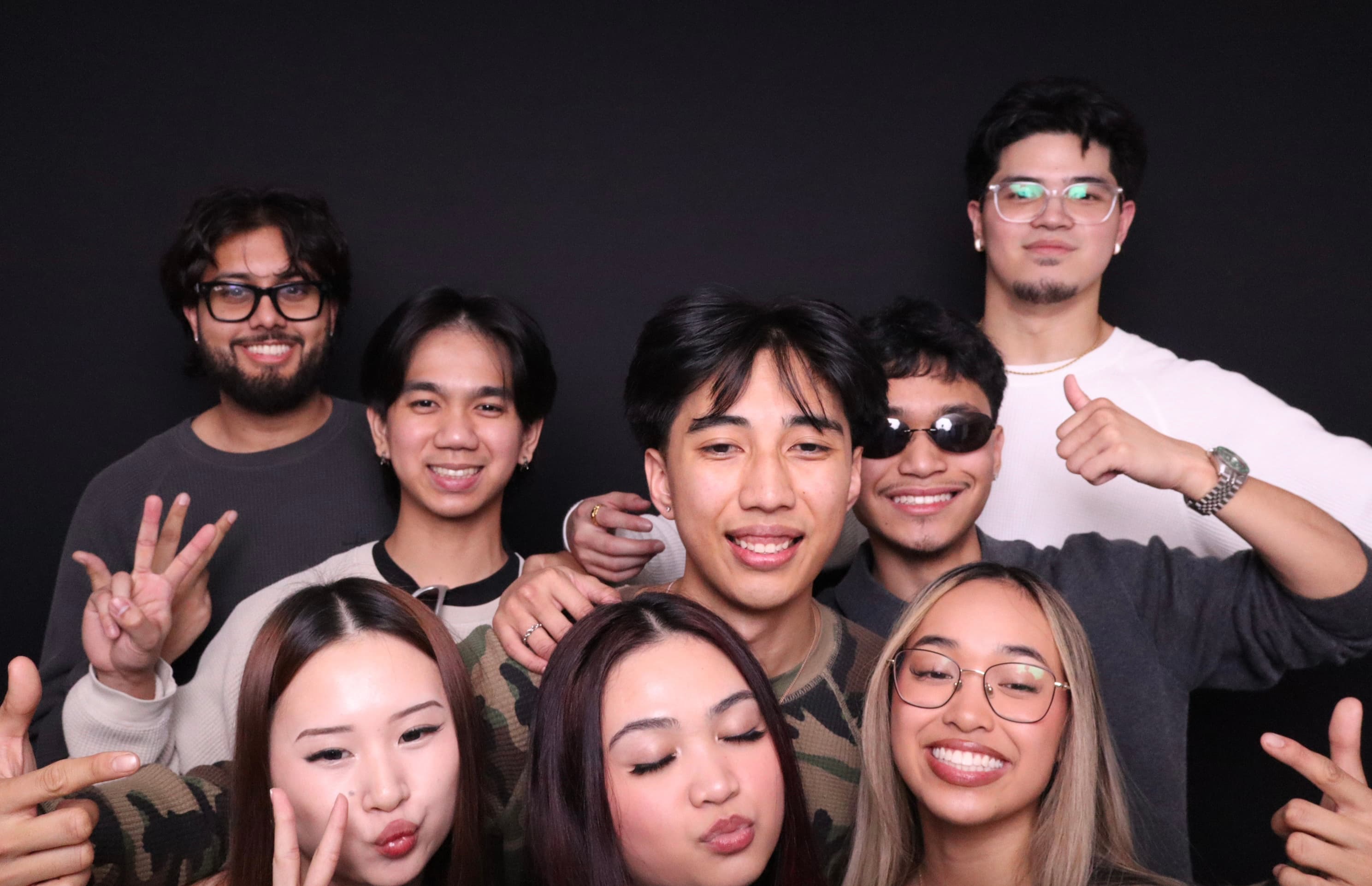 Large group of friends smiling at birthday photo booth Vancouver